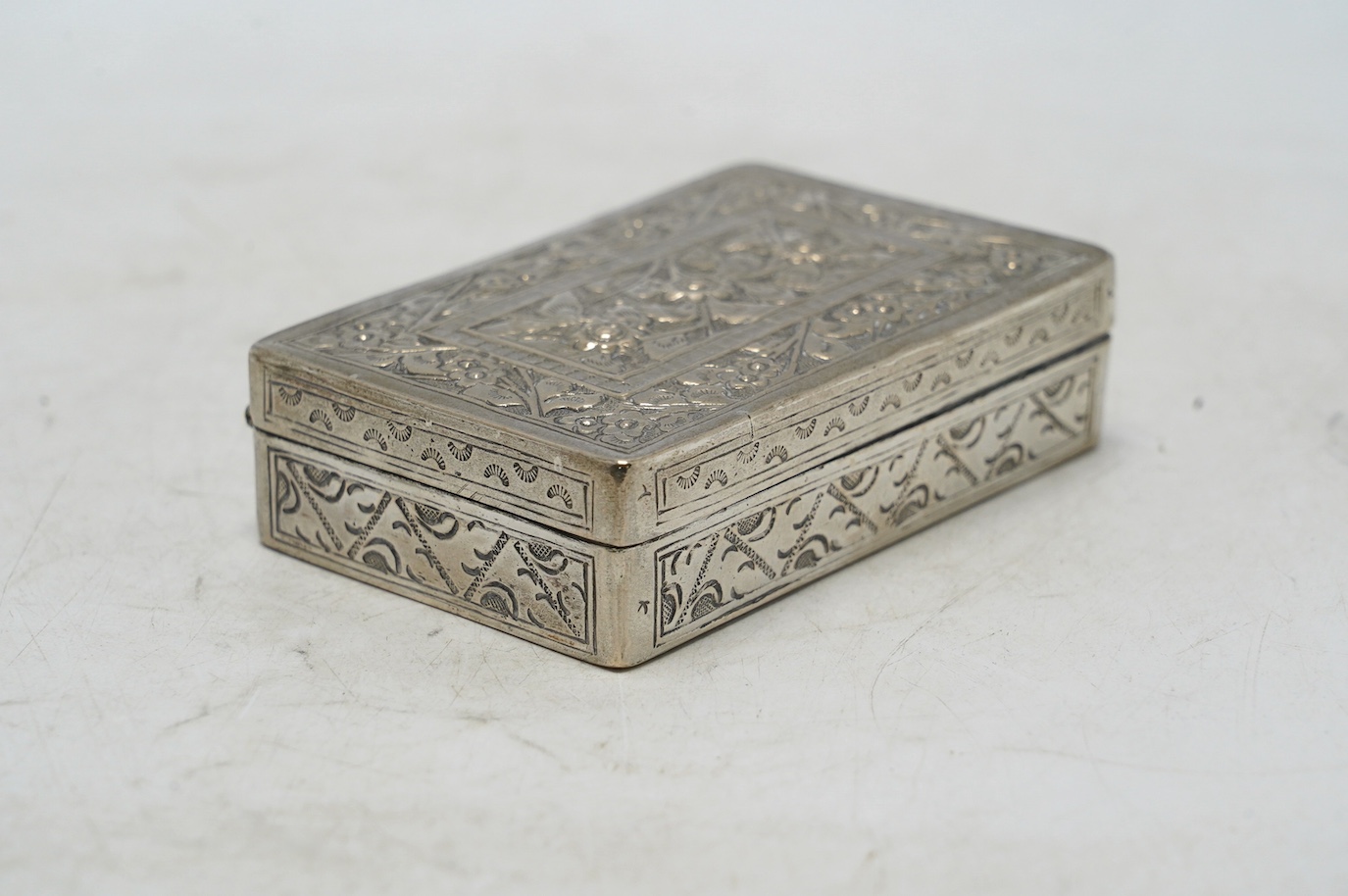 An early 20th century Chinese Export white metal card case by Wang Hing, 84mm, together with a Chinese white metal box with hinged cover. Condition - fair to good